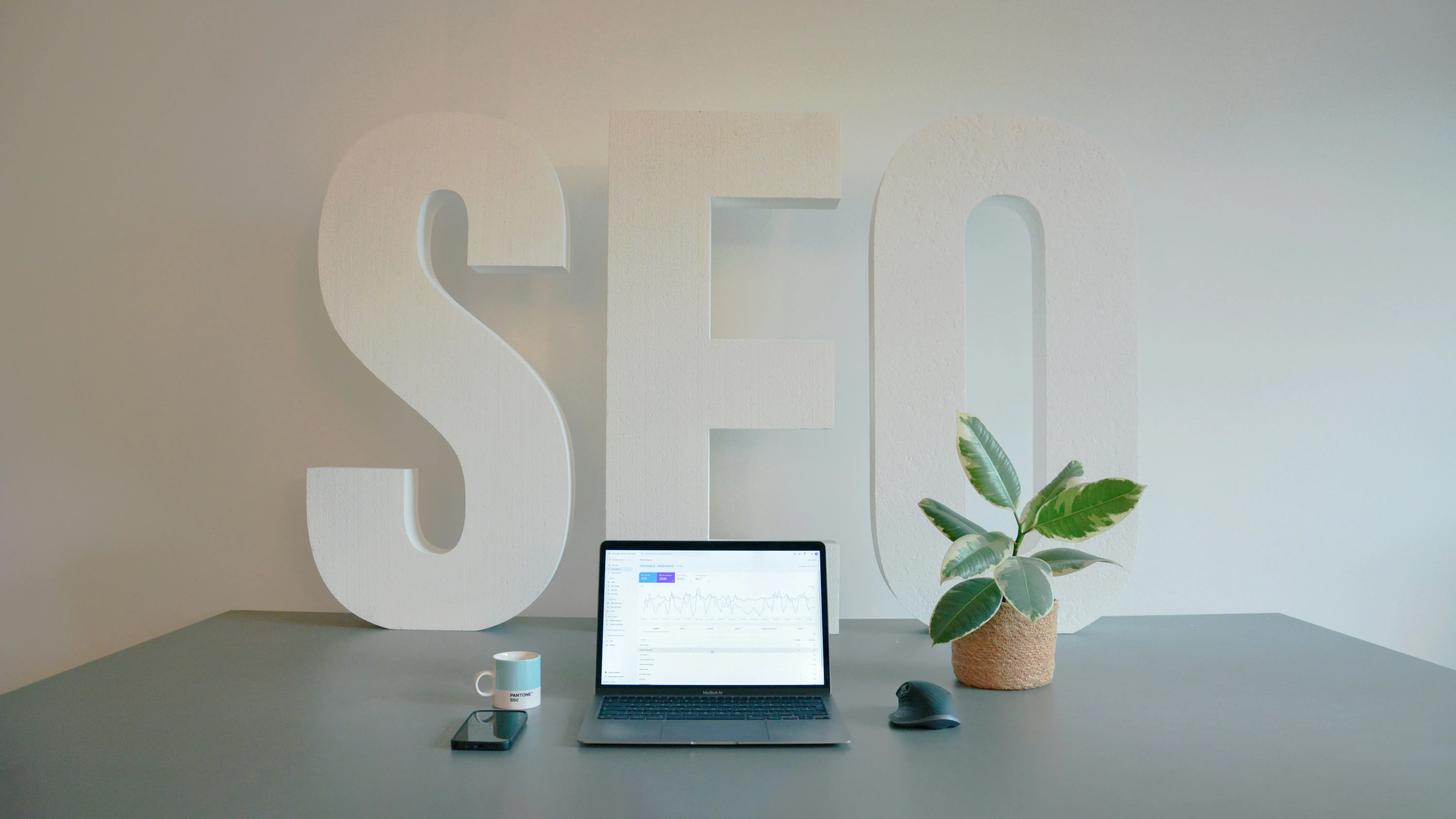 Laptop on a desk with an SEO concept in the background